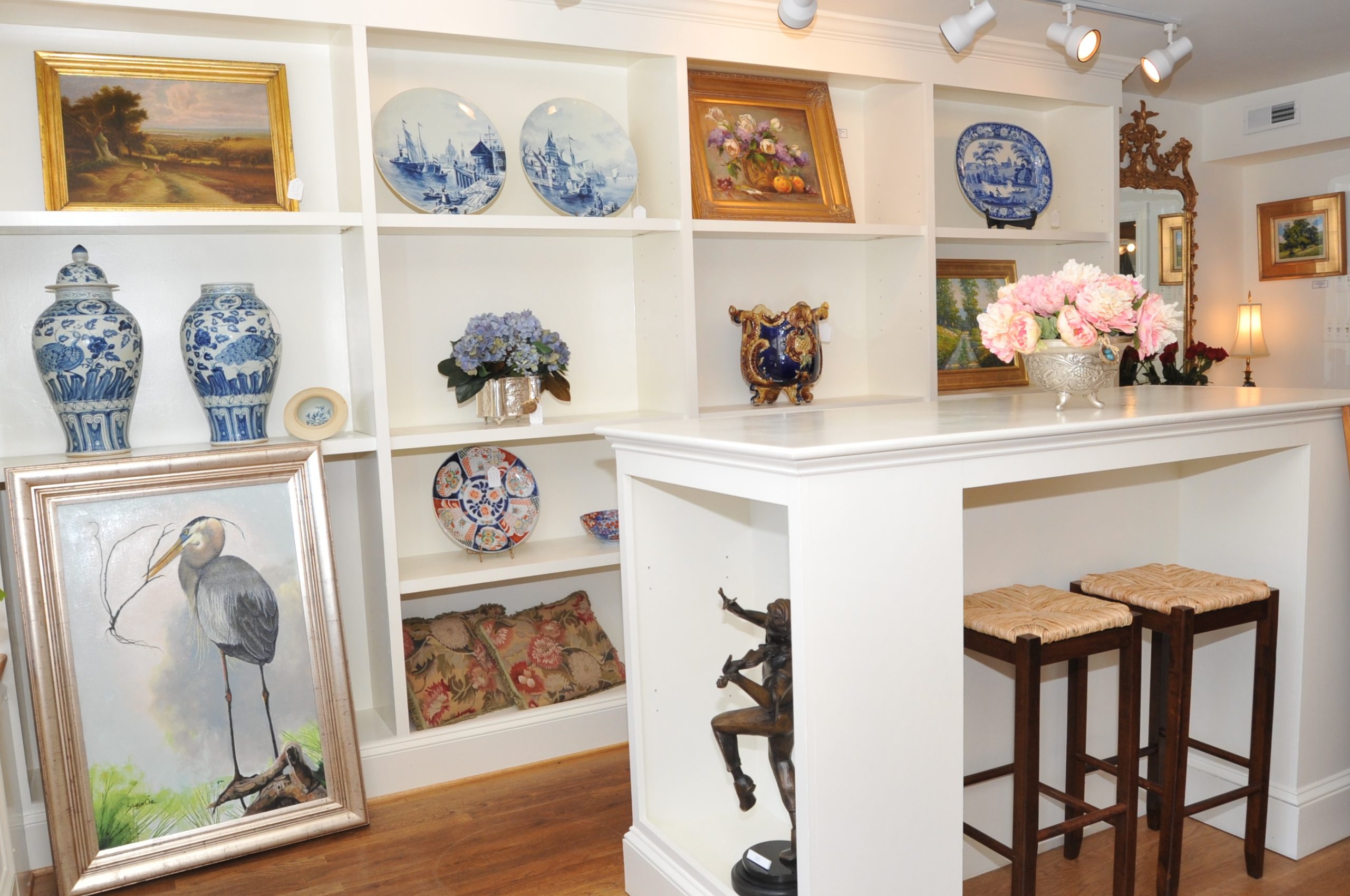 White shelves with paintings and pottery