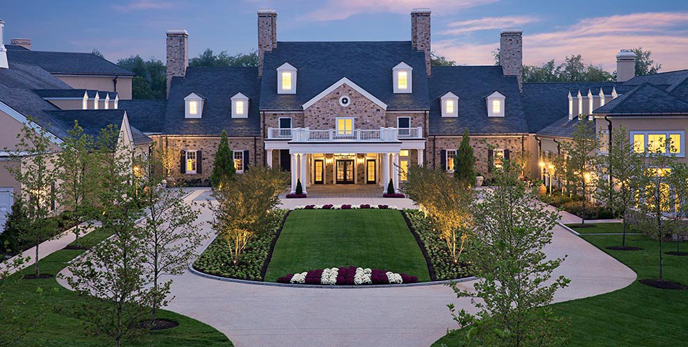 Salamander Resort front entrance lit up at night with courtyard and flowers