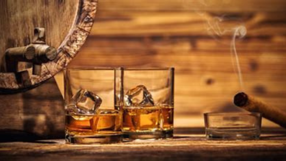 2 glasses of Whiskey on ice with a cigar
