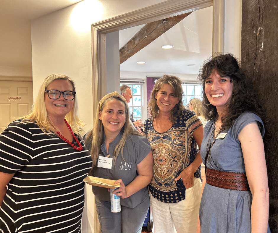 4 women in doorway at a meeting