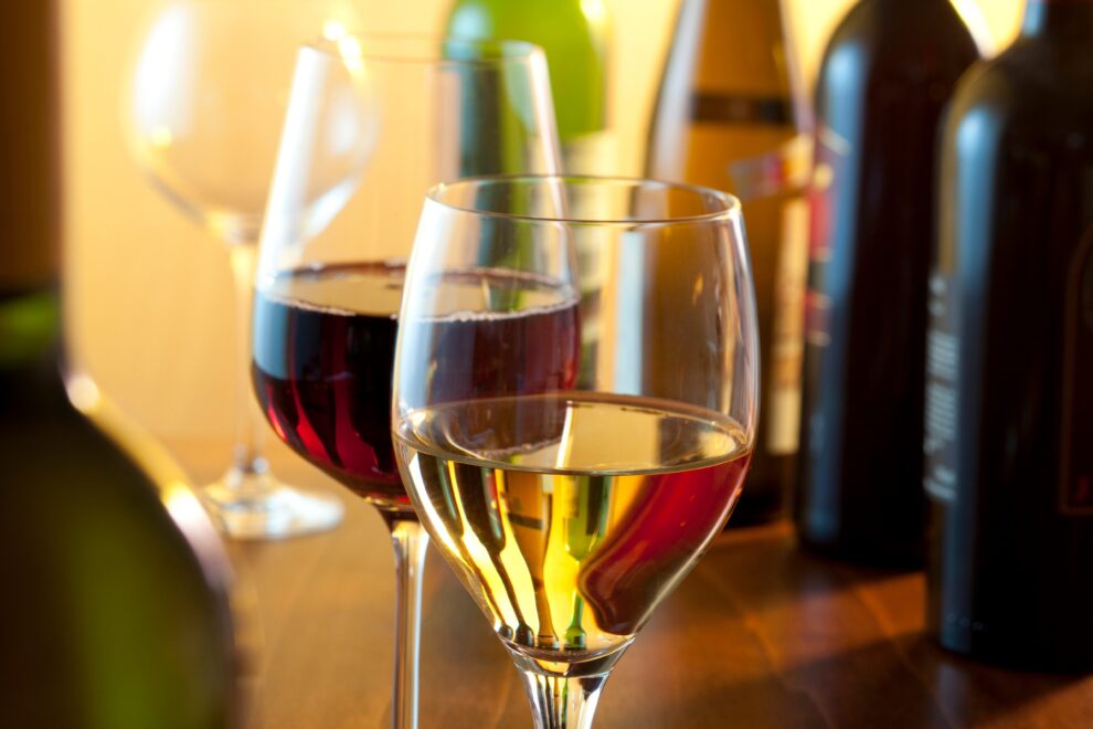wine glass with white wine next to glass with red wine