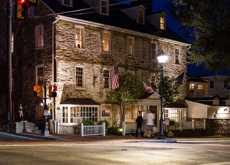 Stone building on corner, lit at night